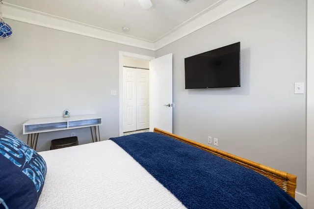 a bedroom with a bed and a mirror on dresser