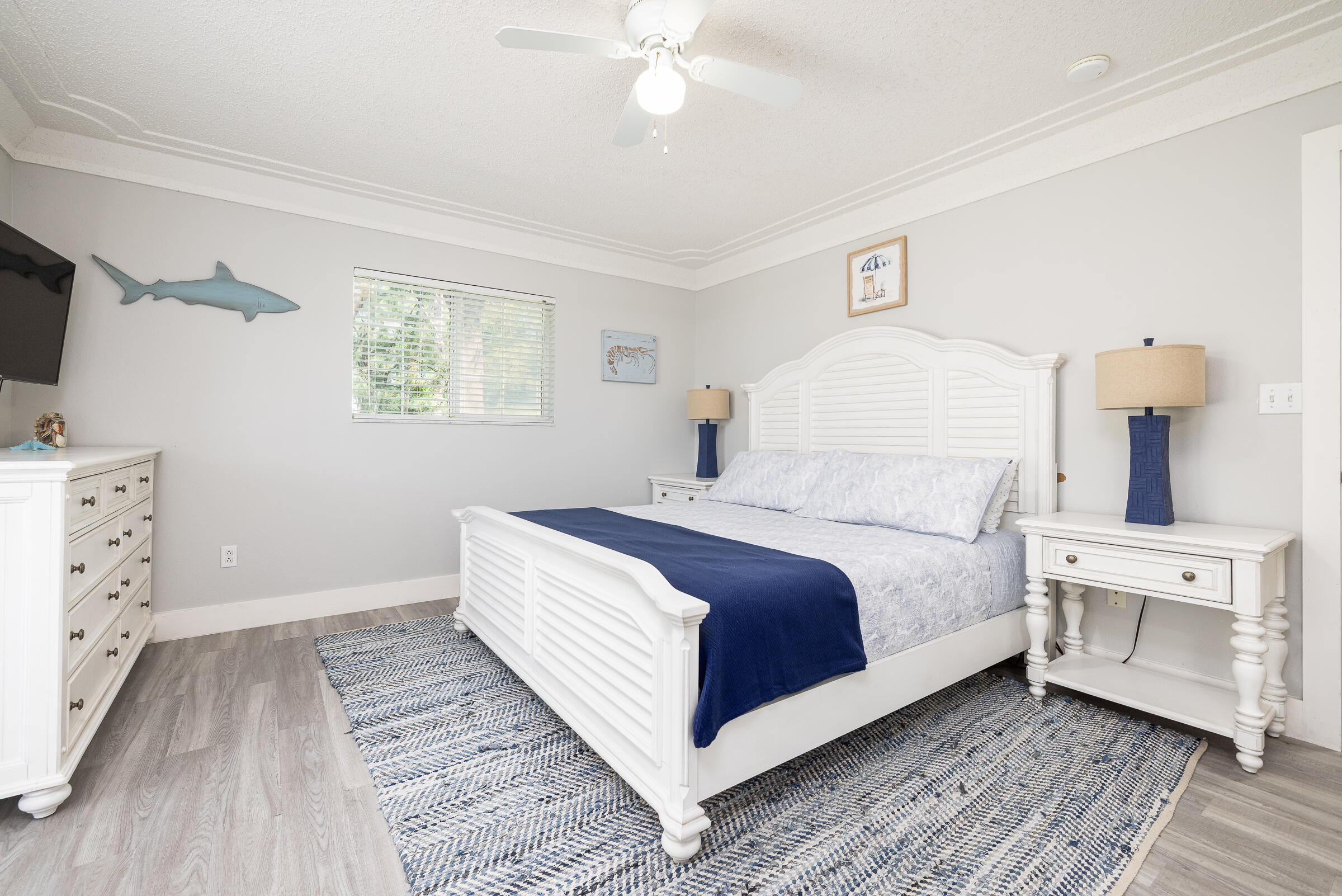 18 Bounty Lane Key Largo, FL 33037 - Photo 28 of 73 a bedroom with a bed and a flat tv screen on the dresser