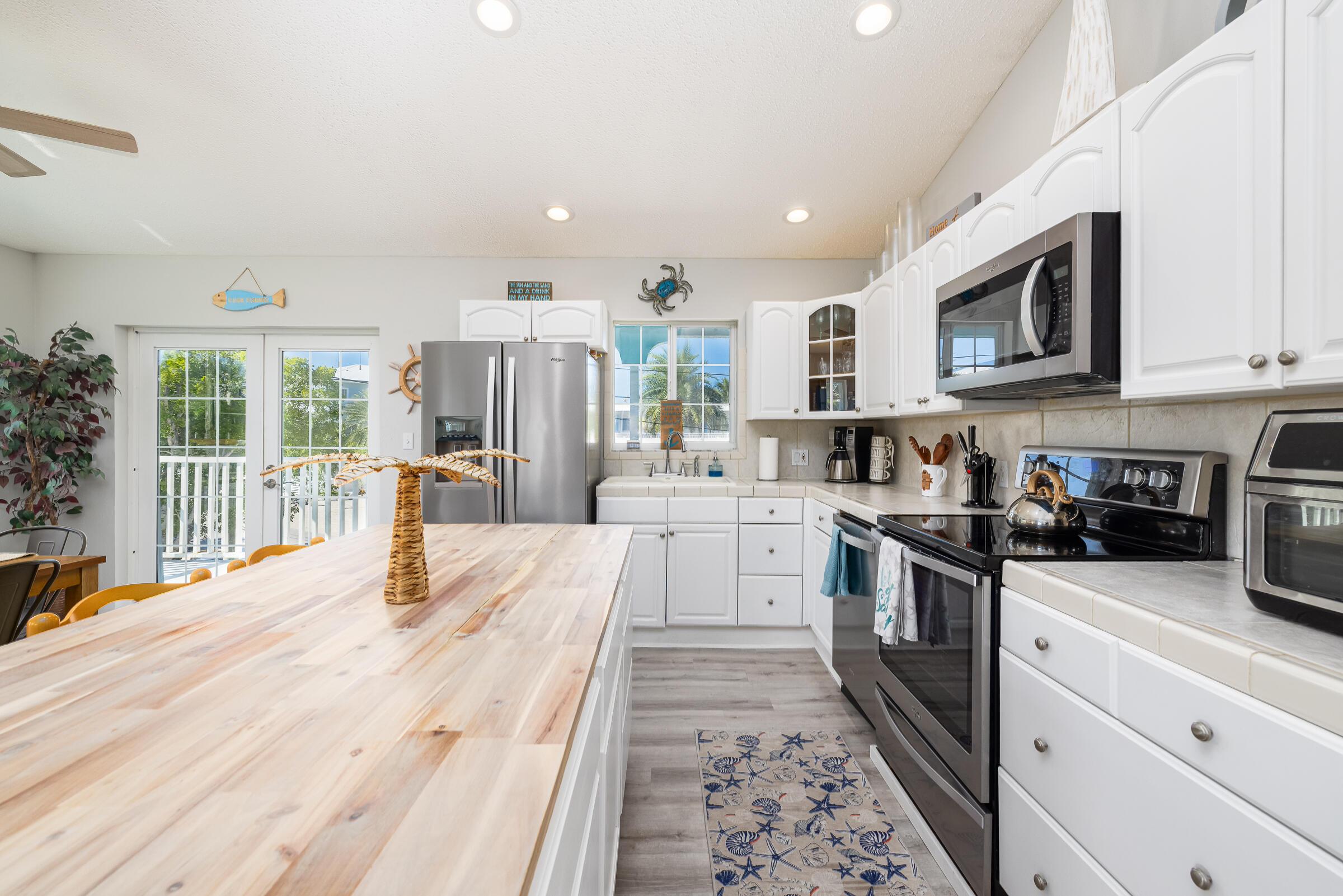 18 Bounty Lane Key Largo, FL 33037 - Photo 7 of 73 a kitchen with stainless steel appliances kitchen island granite countertop a stove sink and cabinets