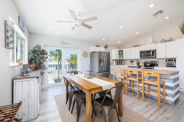 a view of a dining room with furniture and a kitchen