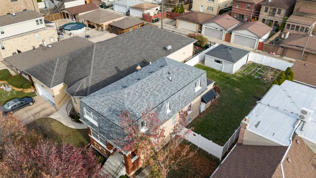 an aerial view of a house with a yard