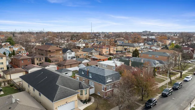 an aerial view of residential houses with city view