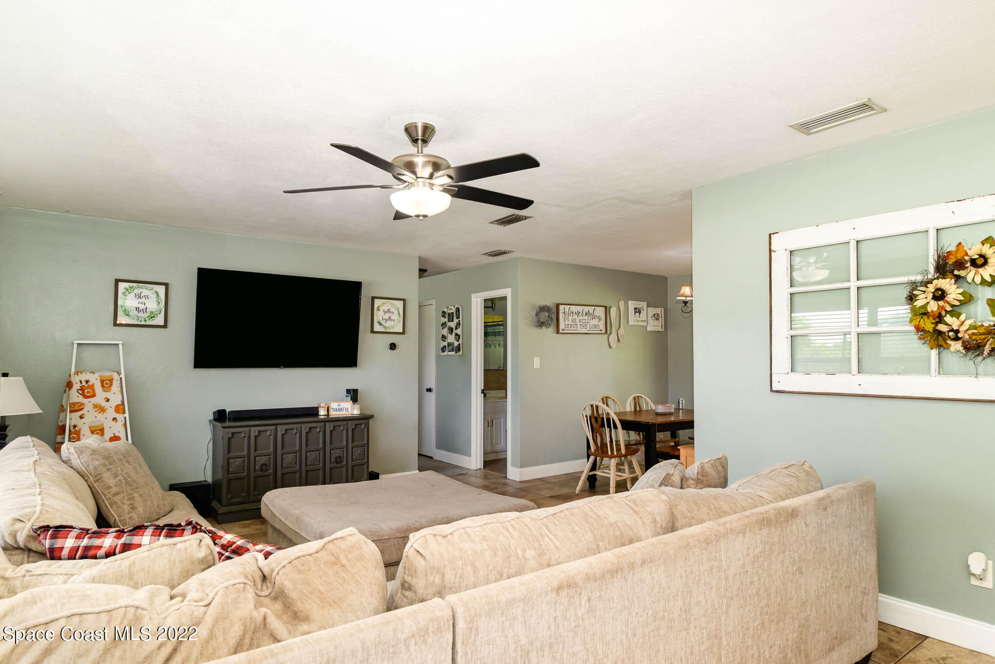 1838 Pinewood Road Melbourne, FL 32934 - Photo 4 of 22 a living room with furniture and a flat screen tv