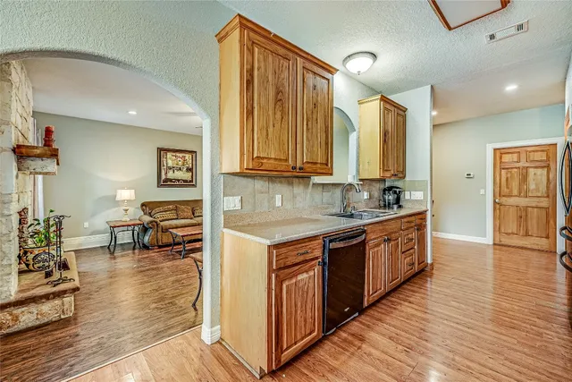 a kitchen with stainless steel appliances granite countertop a stove a sink and a refrigerator