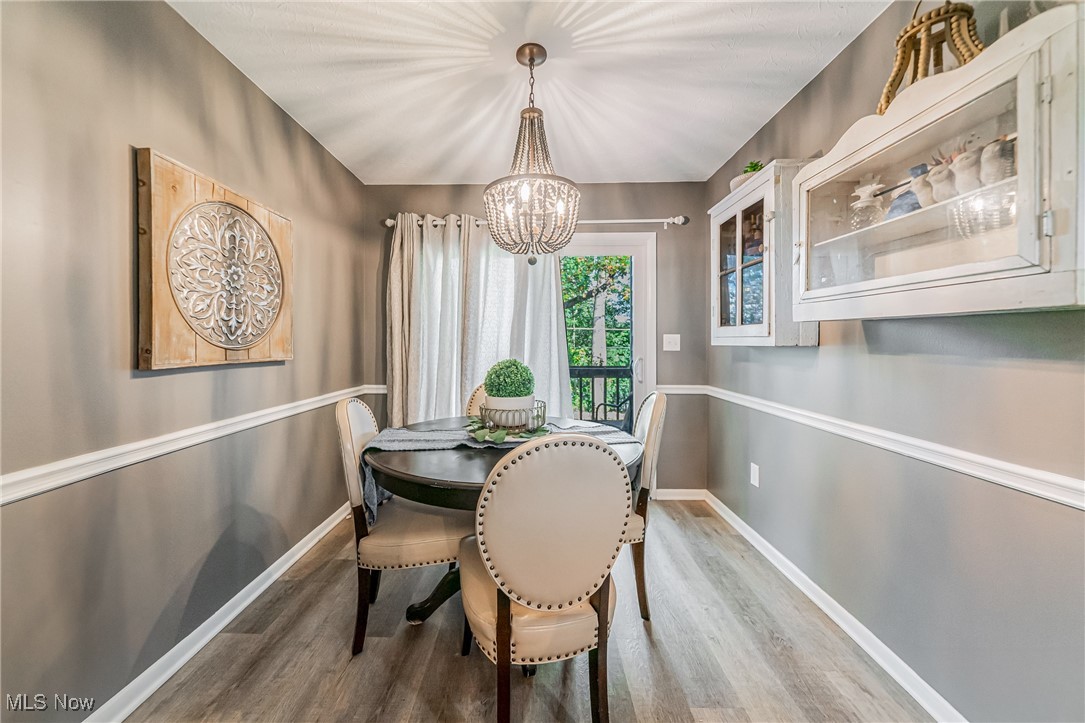 595 Moorfield Road Fairlawn, OH 44313 - Photo 14 of 50 Dining area with light wood-type flooring and a chandelier