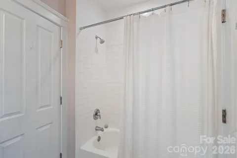 a bathroom with a shower and a tub