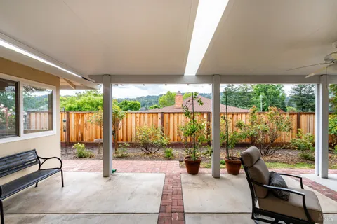 a backyard of a house with table and chairs
