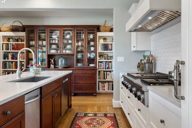 a kitchen with stainless steel appliances granite countertop a stove and a sink