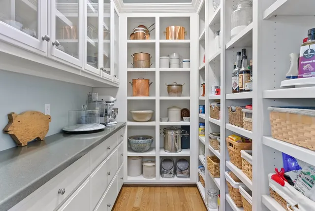 a view of wooden floor and cabinets in a room