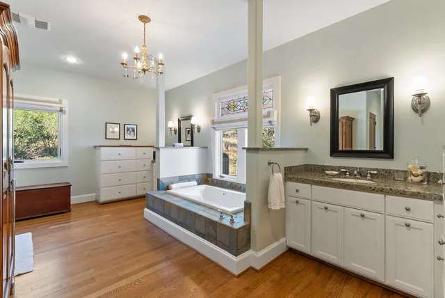 a spacious bedroom with a bed and a dresser