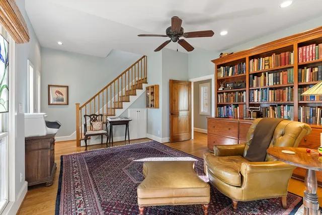 a living room with furniture and a book shelf