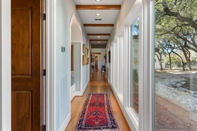 a view of a hallway view with wooden floor and living room