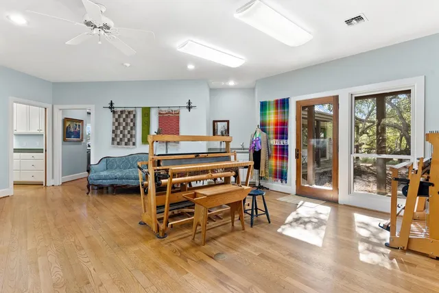 a bedroom with furniture and a wooden floor