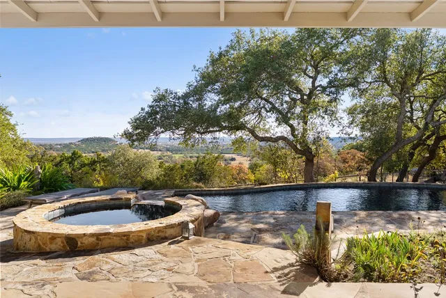 a view of a swimming pool with a yard