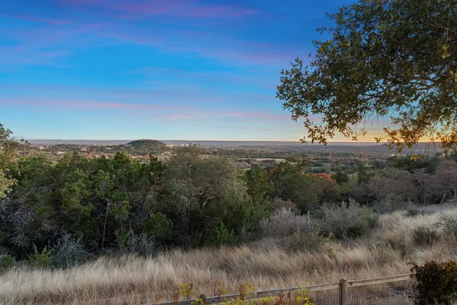 a view of a lake and green valley