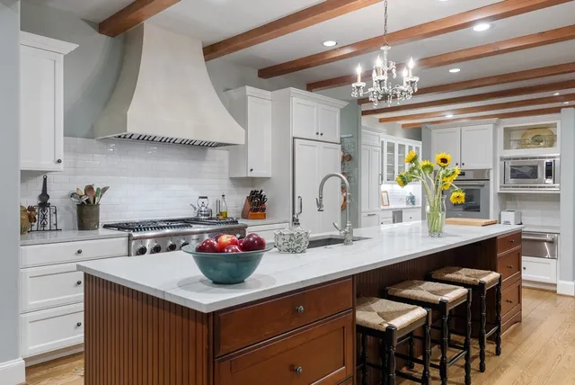 a kitchen with stainless steel appliances granite countertop a sink and a stove