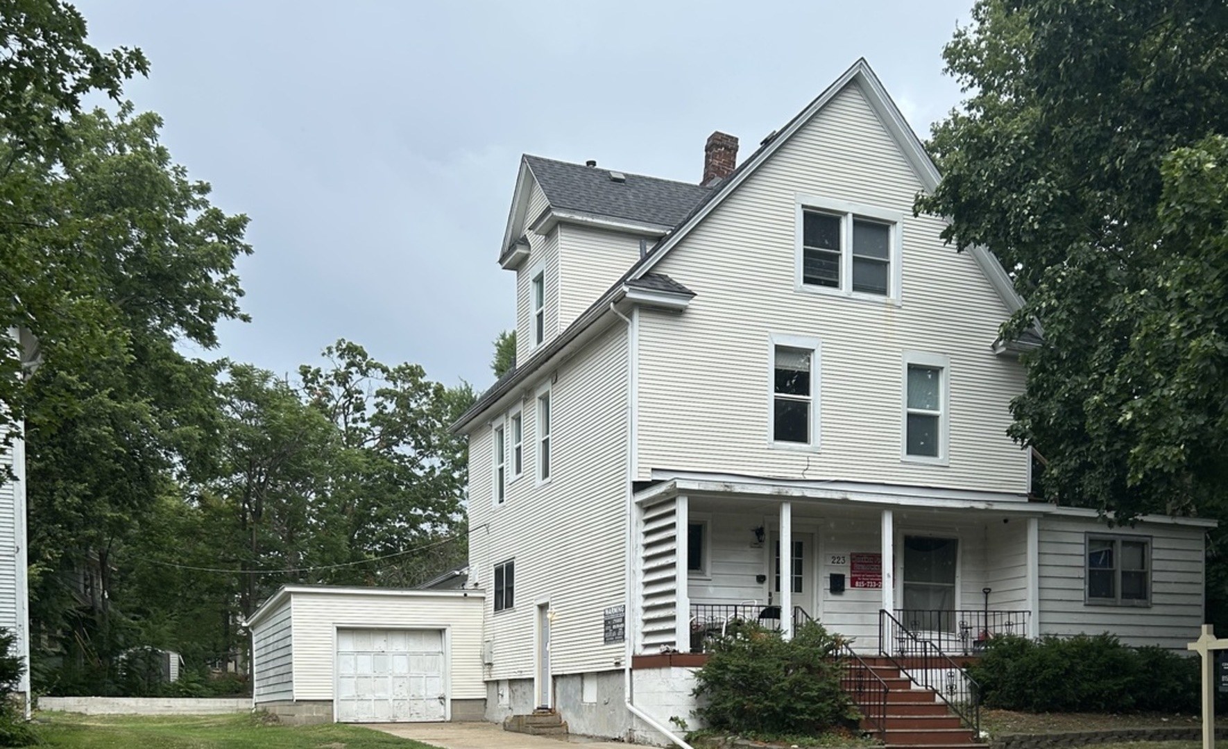 223 West Locust Street DeKalb, IL 60115 - Photo 1 of 1 a view of a white house next to a yard