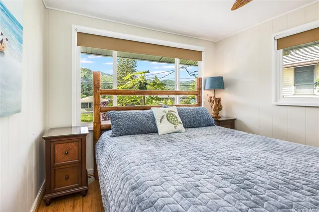 a large bed sitting in a bedroom next to a window
