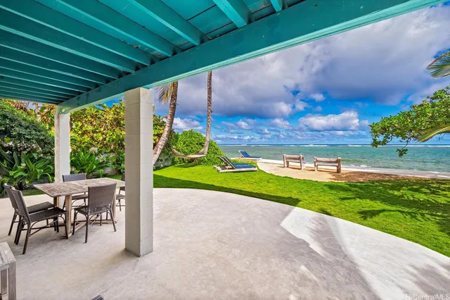 a view of a porch with furniture and garden