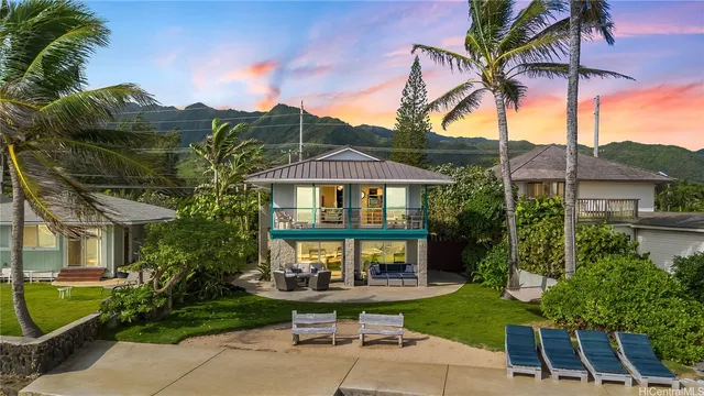 a front view of a house with a garden and patio