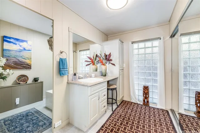 a view of a bathroom with a sink and a mirror
