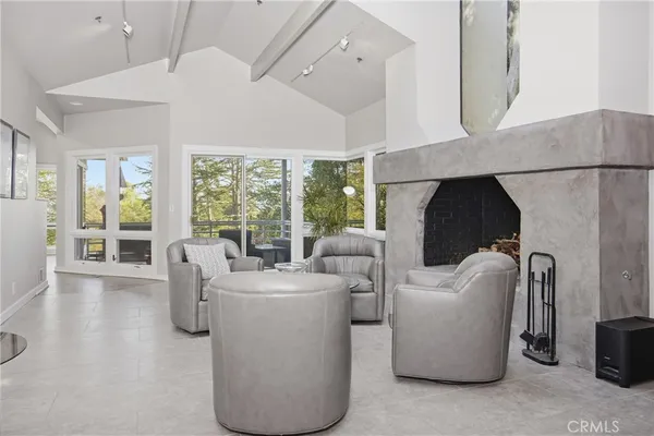 a living room with furniture and a floor to ceiling window