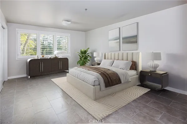 a spacious bedroom with a bed and a couch