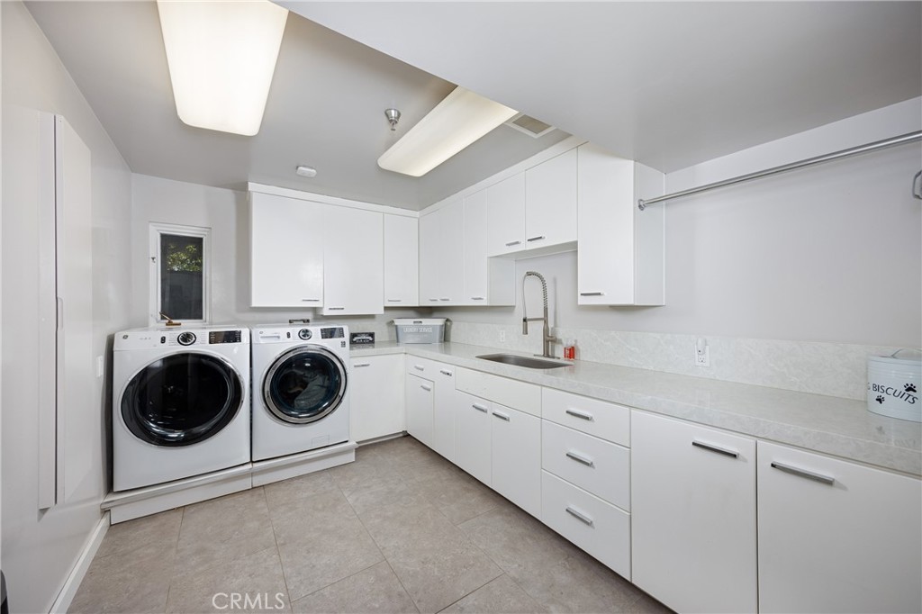 31561 Peppertree-Bend San Juan Capistrano, CA 92675 - Photo 25 of 58 a utility room with cabinets dryer and washer