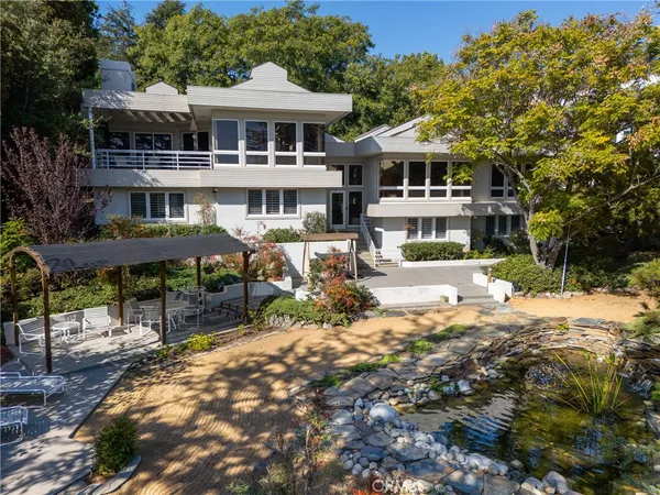a aerial view of a house with a yard and fountain