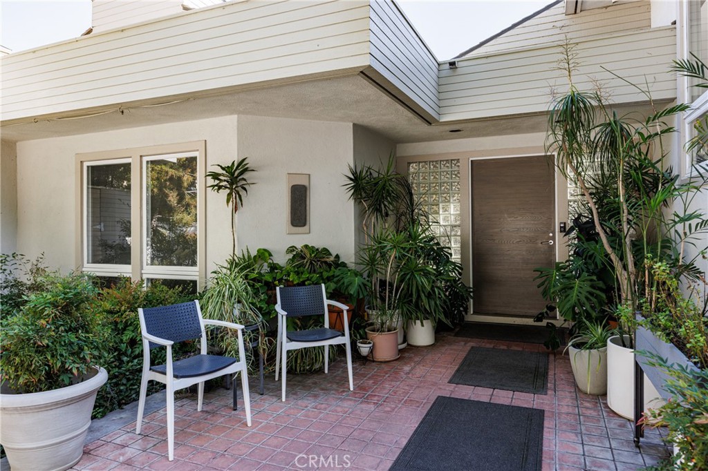 31561 Peppertree-Bend San Juan Capistrano, CA 92675 - Photo 5 of 58 a view of a patio with table and chairs potted plants and floor to ceiling window