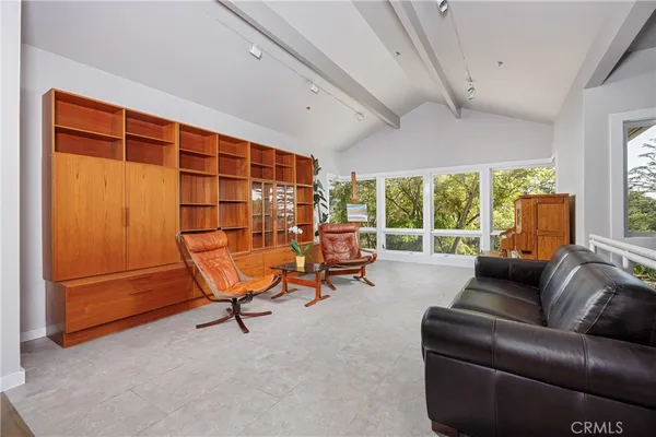 a living room with furniture and a floor to ceiling window