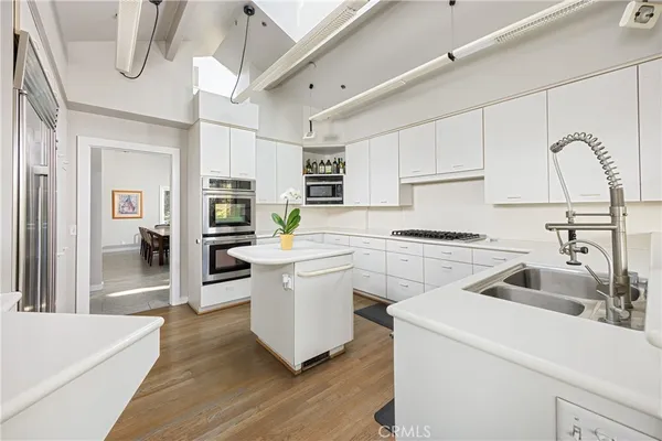 a kitchen with a sink cabinets and window