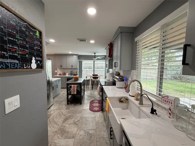 a kitchen with stainless steel appliances a sink a stove and a refrigerator