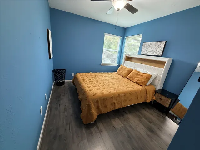 a bedroom with a bed and a ceiling fan