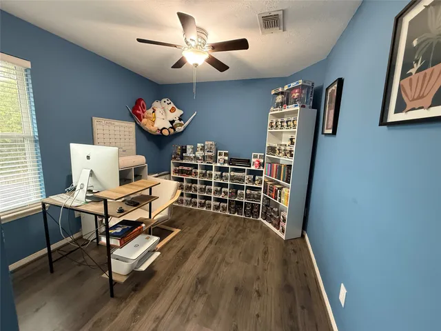 a view of a workspace with furniture and a window