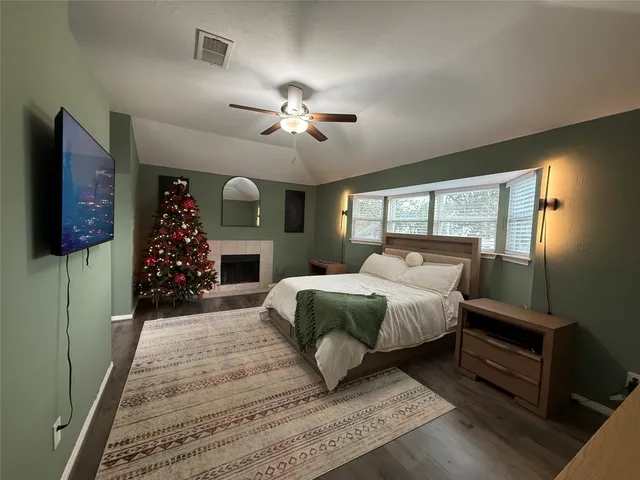 a spacious bedroom with a large bed and a chandelier