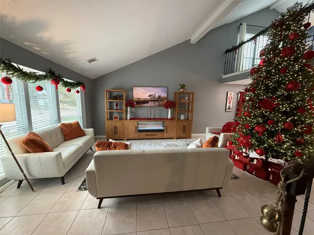 a living room with furniture and a potted plant