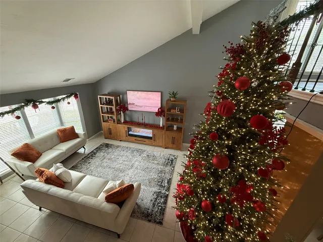 a living room with furniture flowers and a potted plant