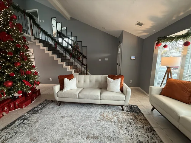 a living room with furniture and flowers