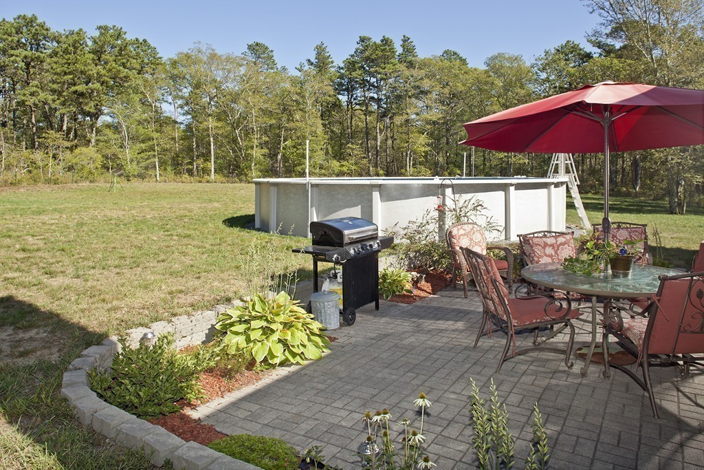 48 Roxy Cahoon Road Plymouth, MA 02360 - Photo 13 of 14 a view of a chairs and table in the patio with a lake