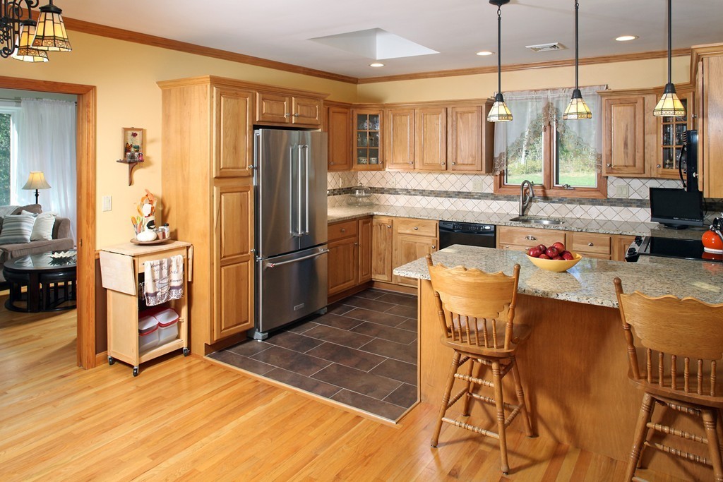 48 Roxy Cahoon Road Plymouth, MA 02360 - Photo 4 of 14 a kitchen with stainless steel appliances granite countertop a refrigerator a stove and a sink