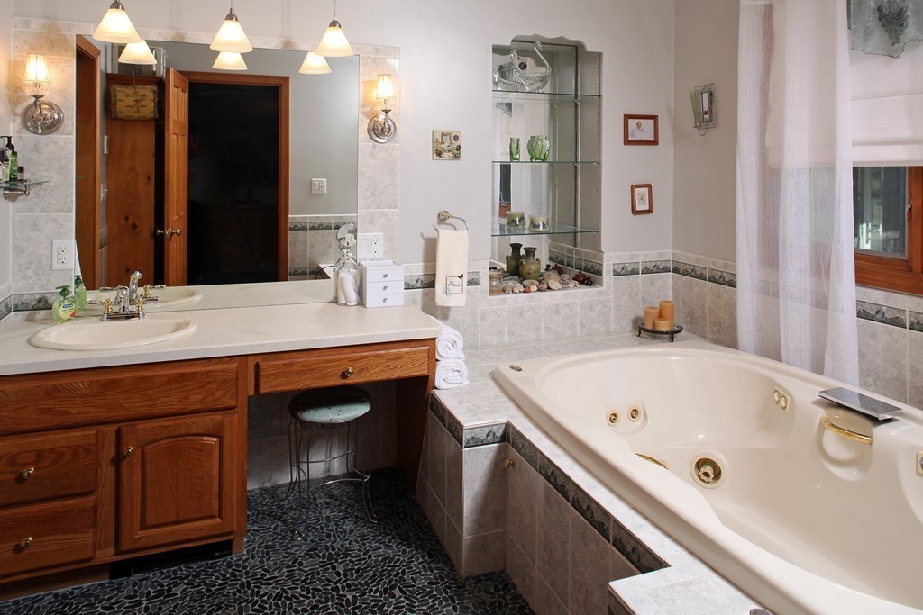 48 Roxy Cahoon Road Plymouth, MA 02360 - Photo 9 of 14 a bathroom with a tub sink and mirror