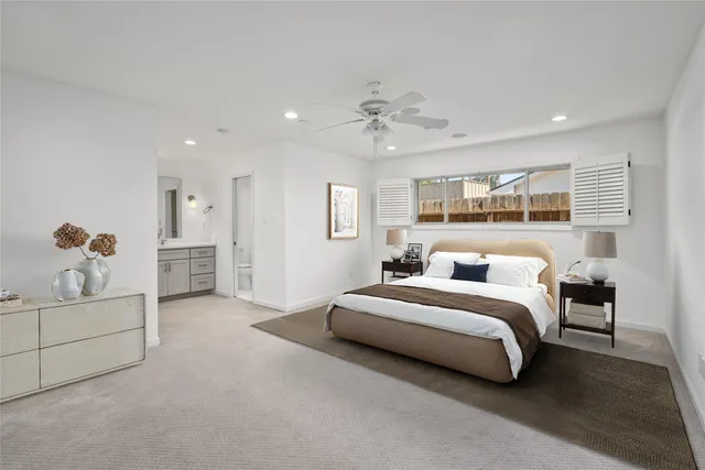a spacious bedroom with a bed and a chandelier