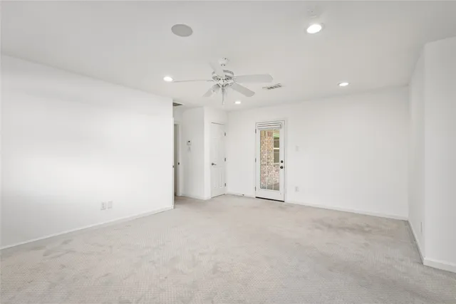 an empty room with fan and a ceiling fan