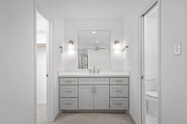 a bathroom with a granite countertop sink two mirror and a