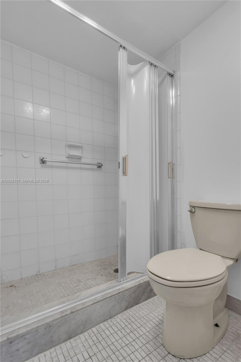 3551 Inverrary Drive, Unit 208 Lauderhill, FL 33319 - Photo 12 of 34 a bathroom with a toilet and a shower