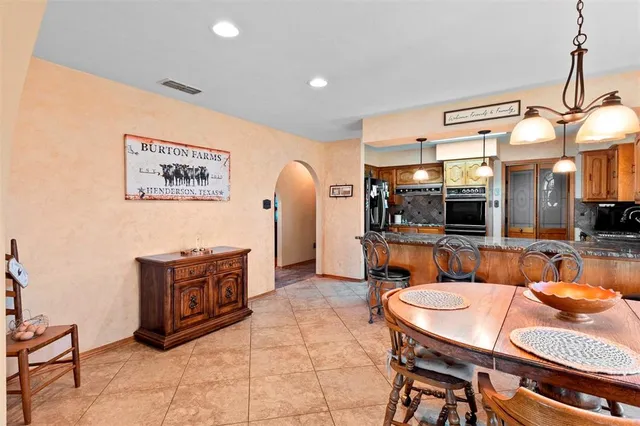 a dining room with a table and chairs