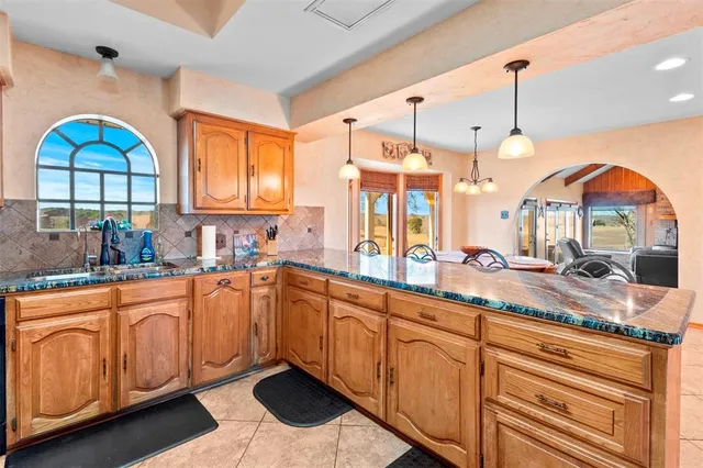 a open kitchen with stainless steel appliances granite countertop a stove a sink and a wooden floors