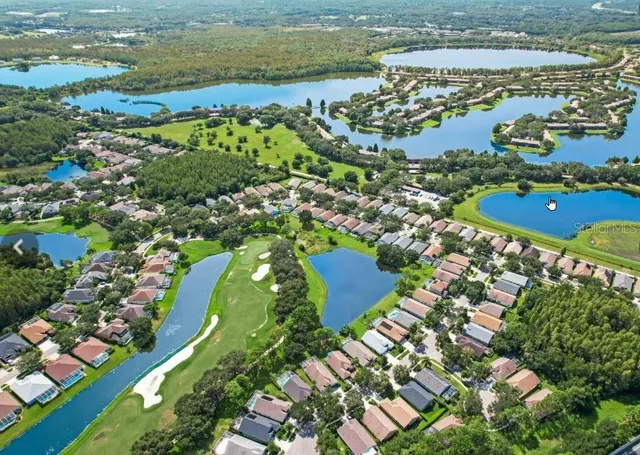 an aerial view of multiple houses with yard