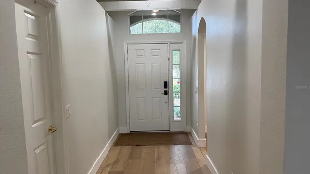a view of a hallway with wooden floor